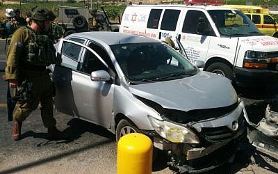 Israeli couple's car after it was struck by another vehicle driven by a Palestinian woman in a possible terror attack at the entrance to Kiryat Arba in the West Bank on June 24, 2016. (Magen David Adom)