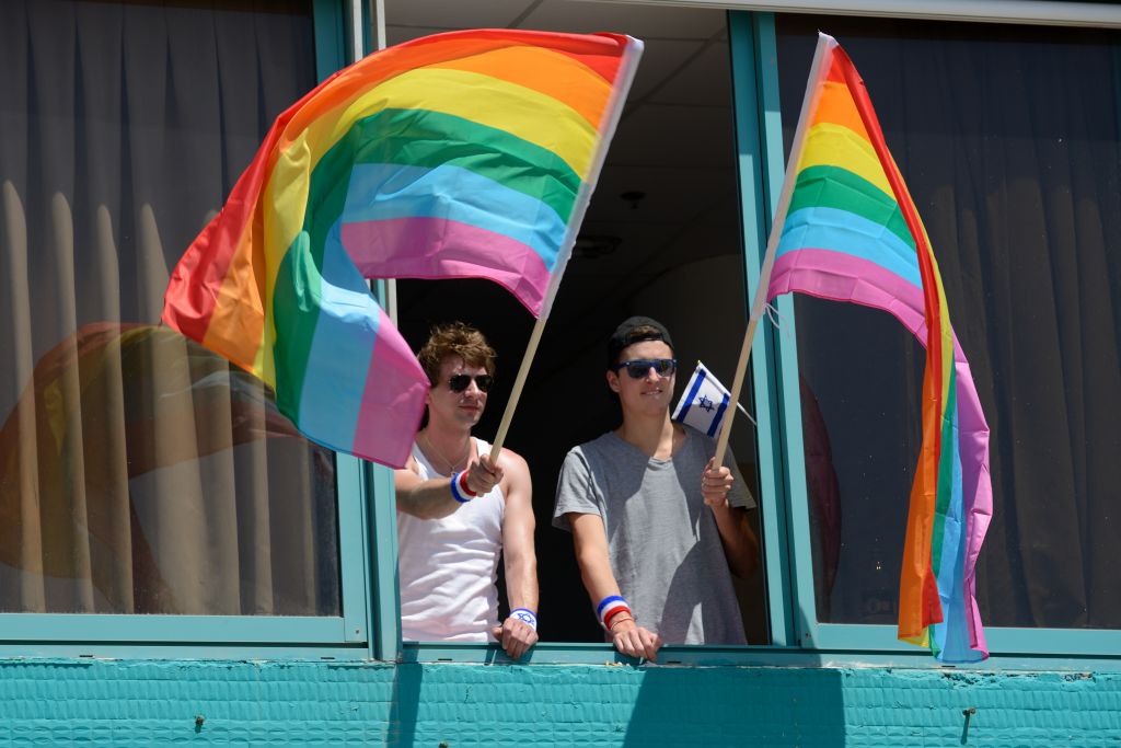 Hanging out the Gay Pride flags in Tel Aviv at the 2015 Gay Pride parade. (Gili Yaari/Flash90)