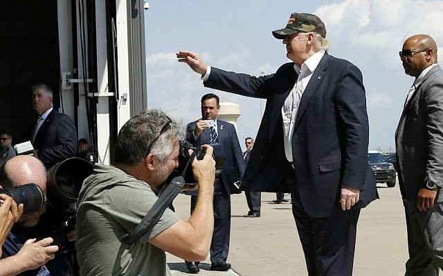 Republican presidential candidate Donald Trump waves to the crowd at a campaign rally, Saturday, June 11, 2016 at a private hanger at Greater Pittsburgh International Airport in Moon, Pennsylvania. (AP Photo/Keith Srakocic)