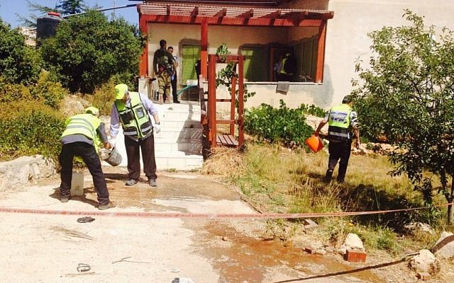 ZAKA volunteers at the scene of a terror attack in Kiryat Arba, on June 30, 2016, in which a 13-year-old girl was stabbed to death in her bedroom. (Nati Shapira)