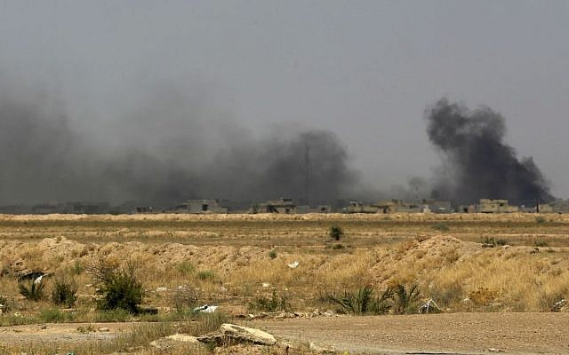 Smoke rises after an airstrike by US-led coalition warplanes as Iraqi security forces advance towards the Shuhada neighborhood of Fallujah, Iraq, Friday, June 3, 2016, during fighting between Iraqi security forces and the Islamic State group. (AP Photo/Khalid Mohammed)