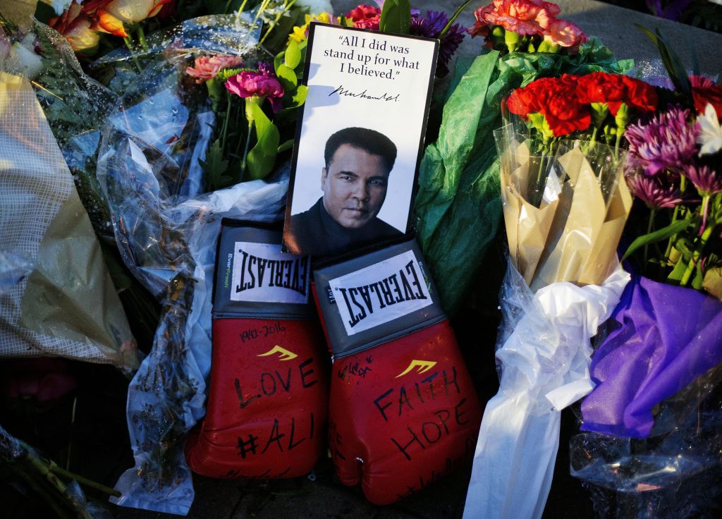 Boxing gloves and a message sit among flowers at a makeshift memorial to Muhammad Ali at the Muhammad Ali Center in Louisville, Kentucky, June 4, 2016. (AP/David Goldman)