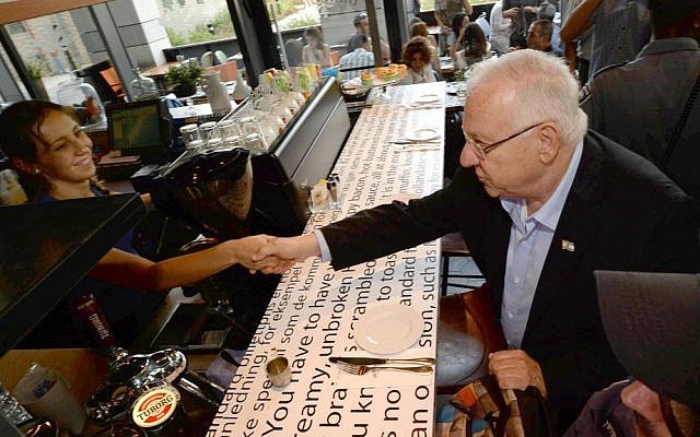 President Reuven Rivlin visit the Sarona Market shopping center in Tel Aviv on June 9, 2016, the morning after a deadly terror attack at the site. (Mark Neiman/GPO)