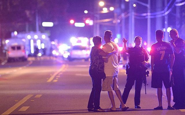 Orlando Police officers direct family members away from a multiple shooting at a nightclub in Orlando, Fla., Sunday, June 12, 2016. (AP Photo/Phelan M. Ebenhack)