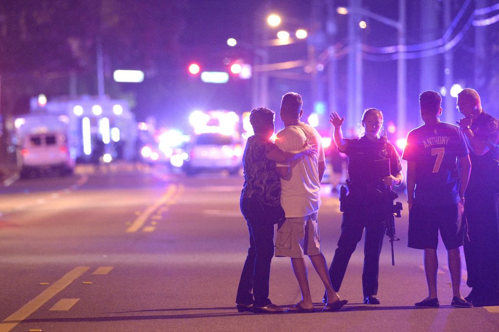 Orlando Police officers direct family members away from a multiple shooting at a nightclub in Orlando, Fla., Sunday, June 12, 2016. (AP Photo/Phelan M. Ebenhack)