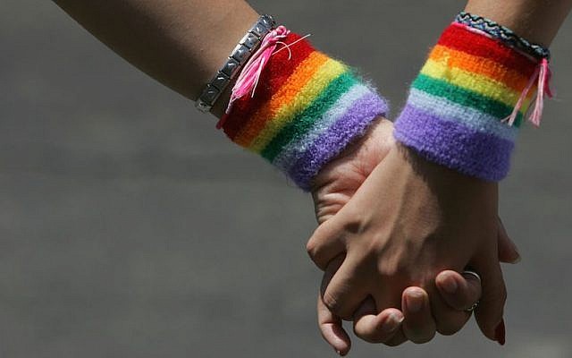 A lesbian couple hold hands during the Tel Aviv Gay Pride parade on June 3, 2016 (David Silverman/Getty Images via JTA, File)