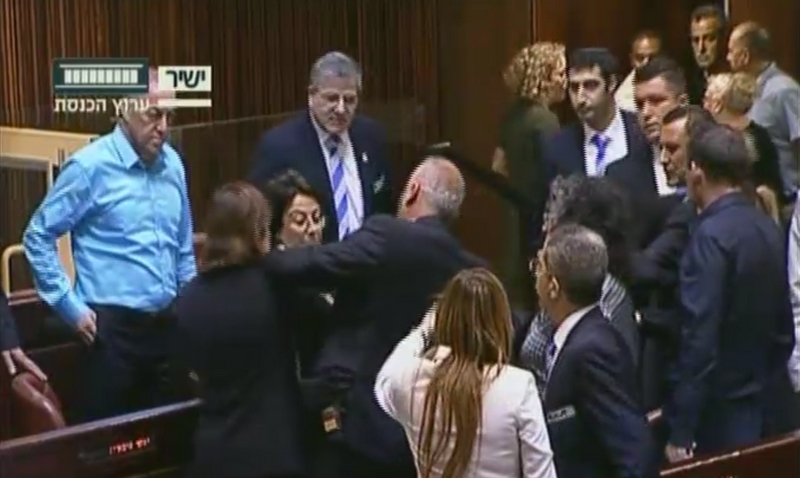 Joint (Arab) List MK Hanin Zoabi, center, rows with fellow lawmakers in the Knesset plenum over her comments on the Israel-Turkey reconciliation agreement on June 29, 2016 (screen capture: Knesset Channel)