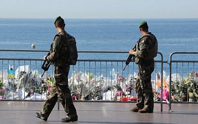 Soldiers pass by the makeshift memorial in tribute to the victims of the deadly Bastille Day attack at the Promenade des Anglais, Nice, July 19, 2016. (AFP/Valery HACHE)