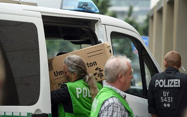 Police officers carry seized material after searching an appartment in the Dachauer Strasse in Munich on July 23, 2016, a day after a gunman went on a shooting rampage in the shopping mall Olympia Einkaufzentrum OEZ, killing nine people.  (AFP PHOTO/DPA/Tobias Hase)