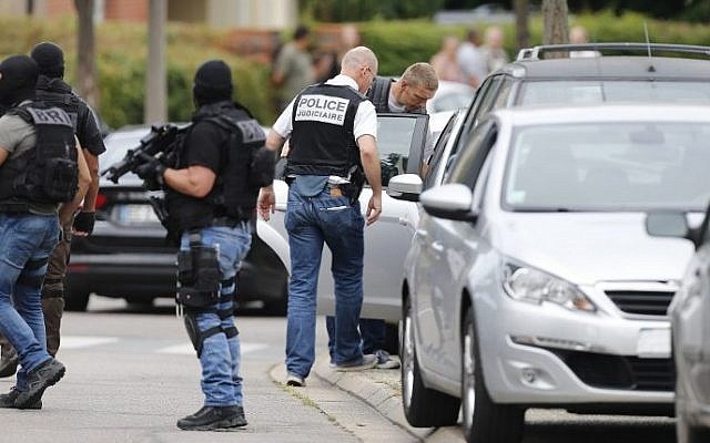 Illustrative: French policemen at the arrest of a man in the Normandy city of Saint-Etienne-du-Rouvray, where an elderly priest was killed by two terrorists who claimed to be acting on behalf of the Islamic State jihadist group, on July 26, 2016. (AFP/Charly Triballeau)