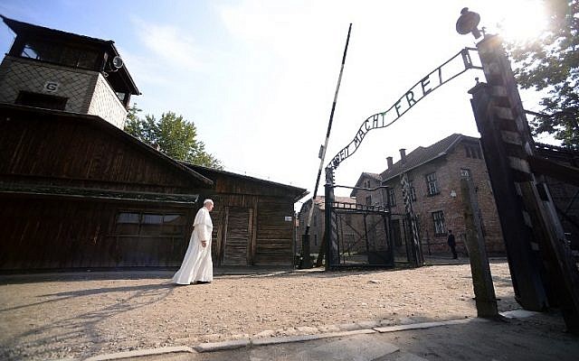 Pope Francis walks towards the main entrance with the lettering 'Arbeit Macht Frei' (Work Sets You Free) at the former Nazi German Auschwitz-Birkenau death camp in Oswiecim, Poland on July 29, 2016 (AFP PHOTO/FILIPPO MONTEFORTE)