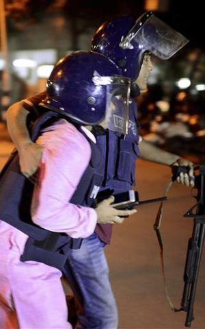 An unidentified security personnel is taken for medical attention after a group of gunmen attacked a restaurant popular with foreigners in a diplomatic zone of the Bangladeshi capital Dhaka, on Friday, July 1, 2016. (AP Photo)