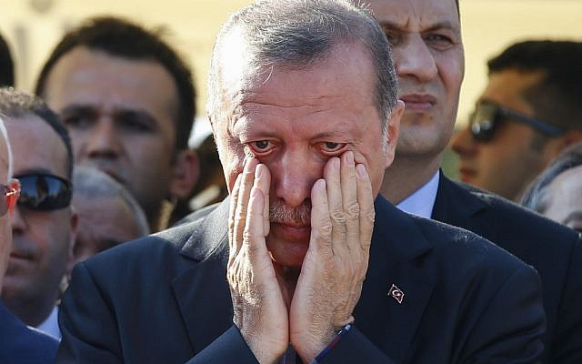 Turkish President Recep Tayyip Erdogan wipes his tears during the funeral of Mustafa Cambaz, Erol and Abdullah Olcak, killed Friday while protesting the attempted coup against Turkey's government, in Istanbul, Sunday, July 17, 2016. (AP Photo/Emrah Gurel)