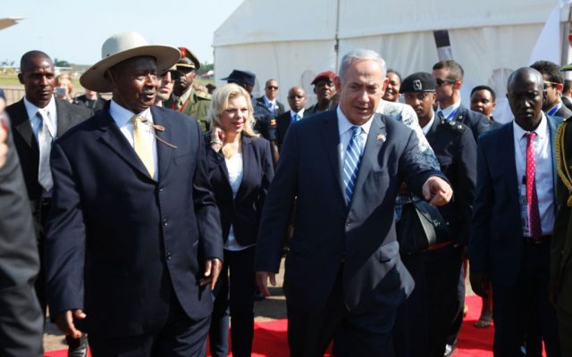 Prime Minister Benjamin Netanyahu, right, is greeted by the Ugandan president, Yoweri Museveni, on his arrival in at Entebbe airport in Uganda on Monday, July 4, 2016 (AP Photo/Stephen Wandera)