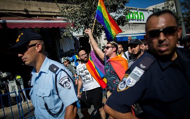 LGBT members surrounded by hundreds of Israeli police officers march on Jaffa street in Jerusalem on August 14, 2015, following the stabbing attack at the annual Jerusalem pride parade on July 30, 2015. (Yonatan Sindel/Flash90)
