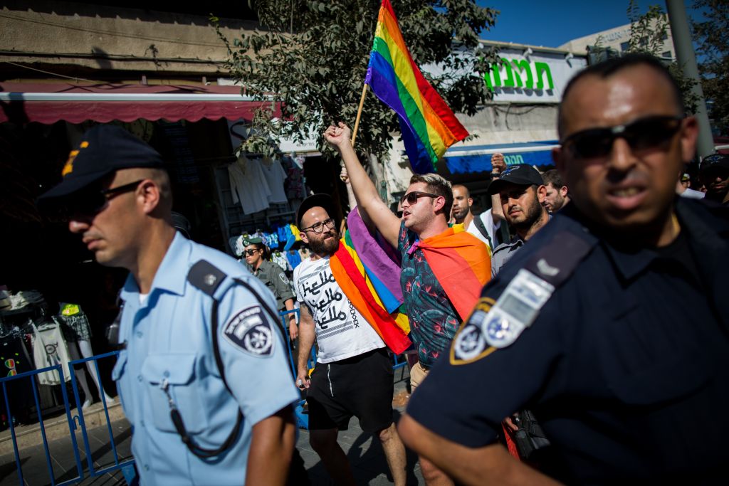 Illustrative: LGBT members surrounded by hundreds of Israeli police officers march on Jaffa street in Jerusalem on August 14, 2015, following the stabbing attack at the annual Jerusalem pride parade on July 30, 2015. (Yonatan Sindel/Flash90)