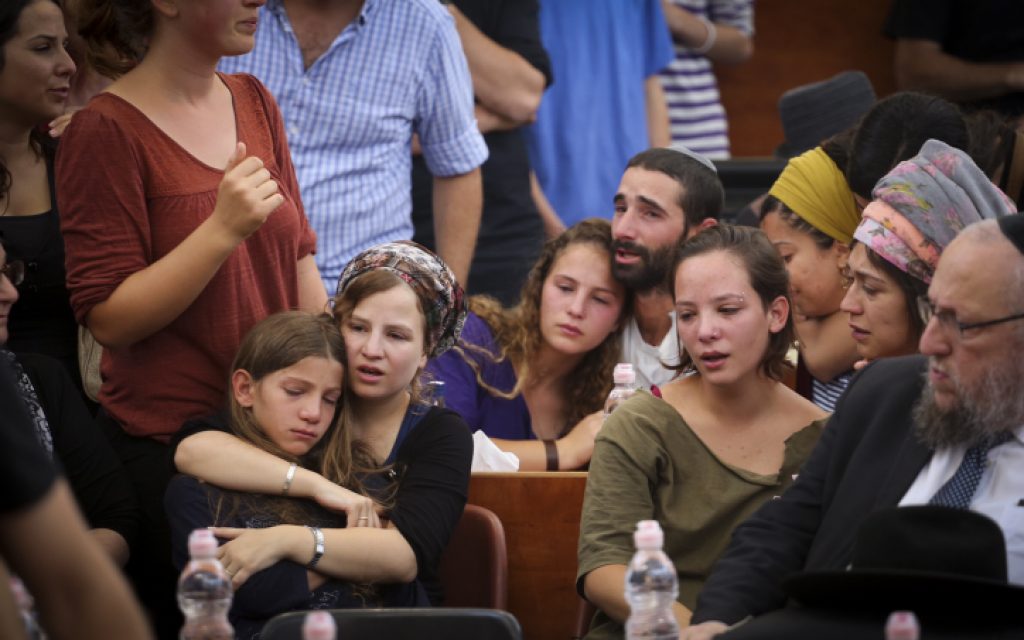 The children of Rabbi Miki Mark mourn at a service prior to his funeral at the Otniel yeshiva, where Rabbi Mark was director, on July 3, 2016. (Hadas Parush/FLASH90)