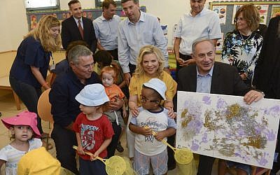 Prime Minister Benjamin Netanyahu and his wife Sara during a visit to Aleh Negev, a rehabilitation village for disabled children and adults near Ofakim in southern Israel, on July 28, 2016. (Haim Zach/GPO)