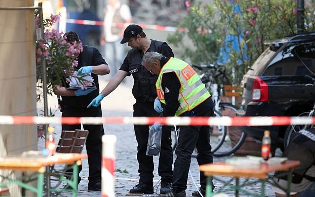 German police investigate at the site in Ansbach, Germany, Monday, July 25, 2016, where a failed asylum-seeker from Syria blew himself up. (Daniel Karmann/dpa via AP)