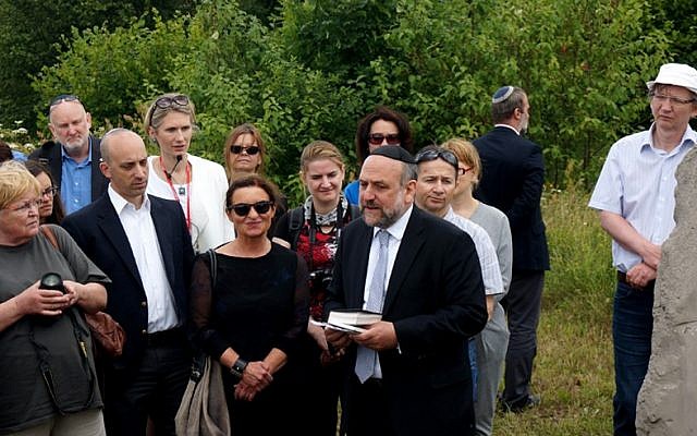 Michael Schudrich, Poland’s chief rabbi, reciting a prayer for the victims of the Jedwabne massacre at the town’s Jewish cemetery, July 10, 2016. Jonathan Greenblatt, CEO and national director of the Anti-Defamation League, is front row, second from left. (JTA/Cnaan Liphshiz)