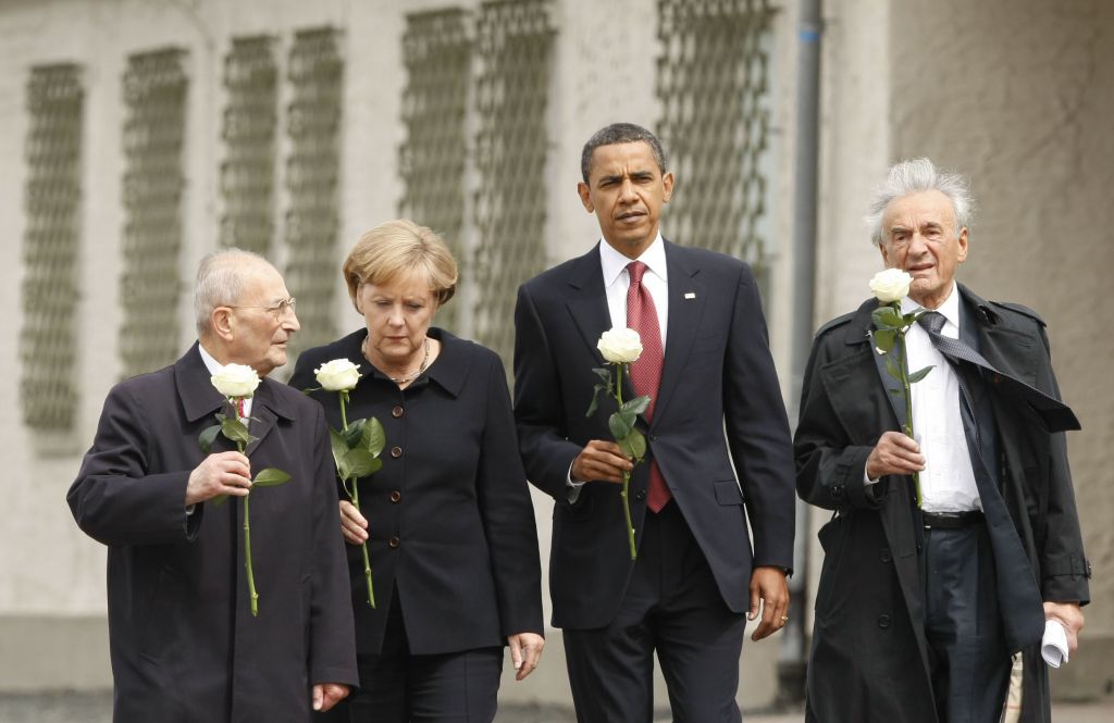 In this June 5, 2009 file photo, U.S. President Barack Obama tours the Buchenwald concentration camp in Buchenwald, Germany. From left are, Holocaust survivor Bertrand Herz, German Chancellor Angela Merkel, the president and Elie Wiesel. (AP Photo/Gerald Herbert)