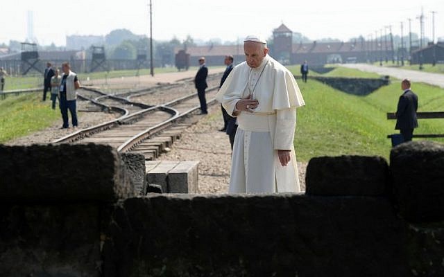 Pope Francis prays in front of a memorial at the former Nazi death camp Auschwitz-Birkenau, in Oswiecim, Poland, July 29, 2016. (L'Osservatore Romano/Pool photo via AP)
