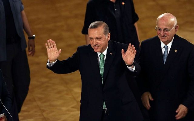 Turkey's President Recep Tayyip Erdogan waves after his address at the parliament in Ankara, Turkey, Friday, July 22, 2016. (AP Photo/Burhan Ozbilici)