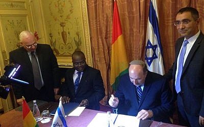Foreign Ministry director-general Dore Gold (second from right) signs a deal to restore diplomatic ties with Guinea in Paris, France on July 20, 2016. (Courtesy Israel Ministry of Foreign Affairs)