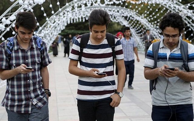 Iranians play on the Pokemon Go app in northern Tehran's Mellat Park on August 3, 2016. (AFP PHOTO / ATTA KENARE)