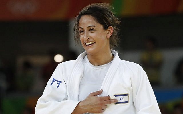 Israel's Yarden Gerbi points to the Israeli flag after defeating Japan's Miku Tashiro to win the bronze medal in the women's -63kg judo contest at the Rio 2016 Olympic Games on August 9, 2016. (AFP PHOTO/Jack GUEZ)