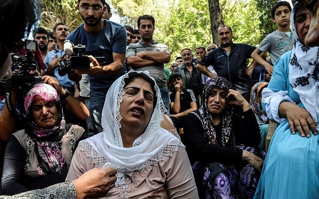 Women cry during a funeral  for a victim of last night's attack on a wedding party that left 50 dead in Gaziantep in southeastern Turkey near the Syrian border, on August 21, 2016. (AFP Photo/Ilyas Akengin)
