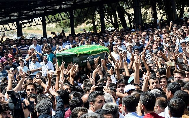 A coffin is carried during the funeral procession of one of the victims from last night's attack on a wedding party that left 50 dead in Gaziantep in southeastern Turkey near the Syrian border on August 21, 2016. (AFP/ILYAS AKENGIN)
