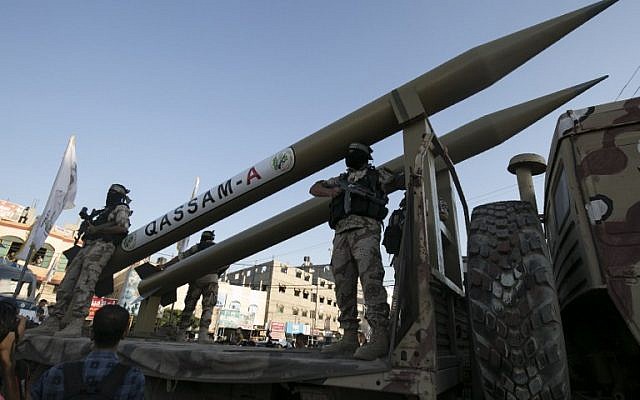 Palestinian members of the al-Qassam Brigades, the armed wing of the Hamas movement, display Qassam home-made rockets during an anti-Israel military parade marking the second anniversary of the killing of Hamas's military commanders Mohammed Abu Shamala and Raed al-Attar on August 21, 2016 in Rafah in the southern Gaza Strip. (AFP  / SAID KHATIB)