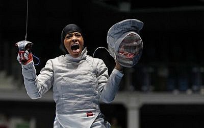 Ibtihaj Muhammad, from the United States, celebrates her defeat over Olena Kravatska, from Ukraine, during the women's saber individual fencing event at the 2016 Summer Olympics in Rio de Janeiro, Brazil, August 8, 2016. (AP/Vincent Thian)