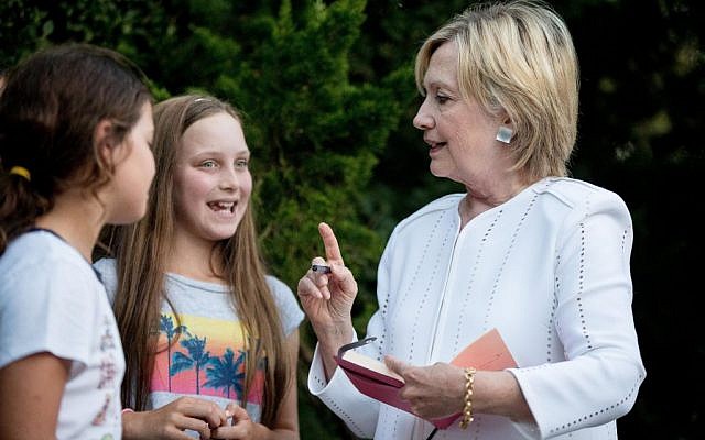 Democratic presidential candidate Hillary Clinton speaks with neighborhood children following a fundraiser at a private home in Sagaponack, New York, August 30, 2016. (AP Photo/Andrew Harnik)