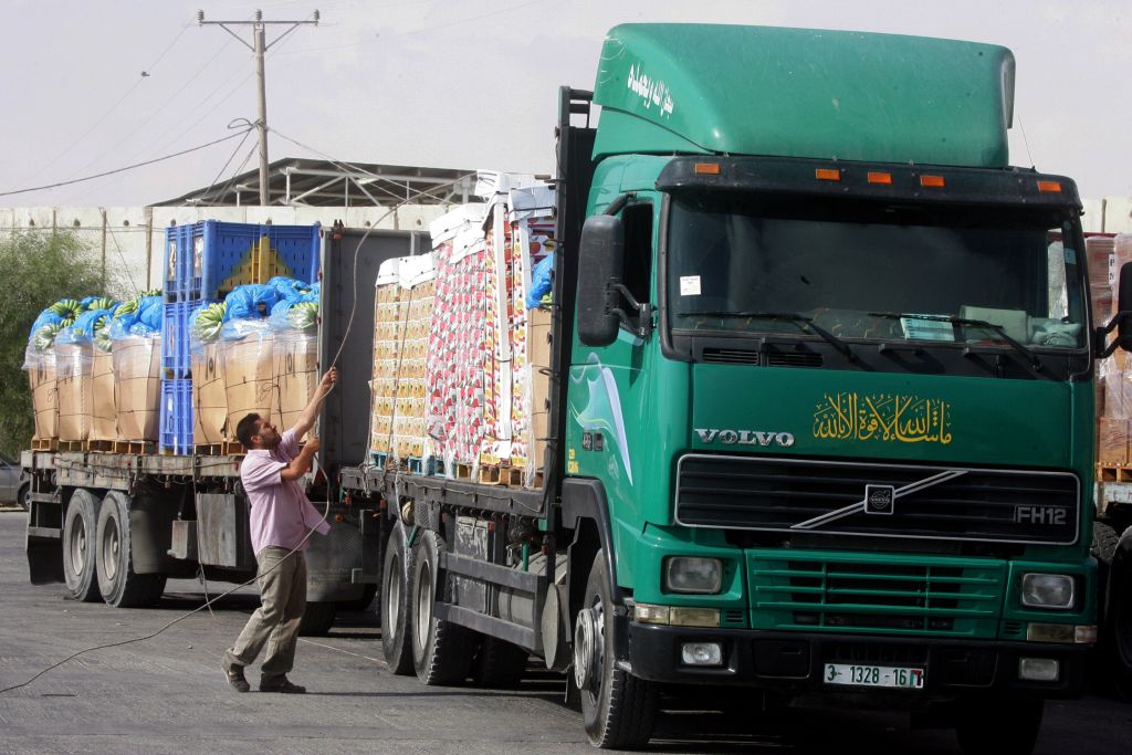 Trucks loaded with aid enter the Gaza Strip from Israel through the Kerem Shalom crossing on October 12, 2014, in Rafah in southern Gaza. (Abed Rahim Khatib/Flash90) 