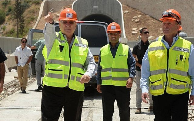 President Reuven Rivlin, left, takes a tour of the construction site for the new high-speed railway train being built between Jerusalem and Tel Aviv, on June 1, 2016. (Photo by Mark Neyman/GPO)