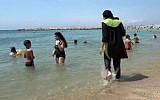 A woman wearing a burkini at the beach in Marseille, southern France. (AP Photo)