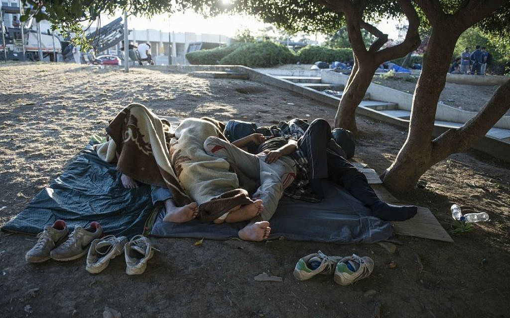 Migrants sleep in a park at the northern Greek city of Thessaloniki on Saturday, July 9, 2016. (AP Photo/Giannis Papanikos)