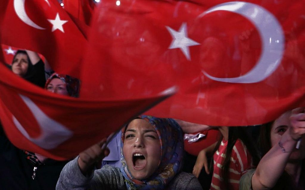 A crowd brandish national flags and shout shouts slogans during a July 25, 2016 anti-coup rally in Istanbul, as a nationalistic fervor engulfs Turkey following the failed military coup attempt. (AP Photo/Petros Karadjias, FILE)