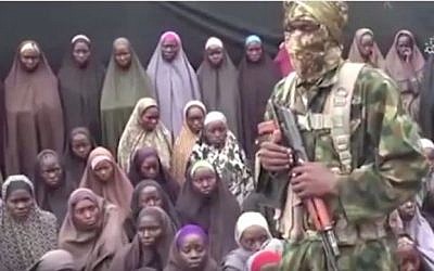 An image taken from a video released on August 14, 2014 by the Nigerian jihadist group Boko Haram purportedly shows dozens of girls kidnapped by the group in 2014. (screen capture: YouTube)