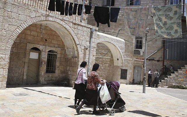 Illustrative: Ultra-Orthodox Jewish women push their baby strollers as they walk in the ultra-Orthodox Mea Shearim neighborhood in Jerusalem, on July 4, 2013. (Nati Shohat/Flash90)