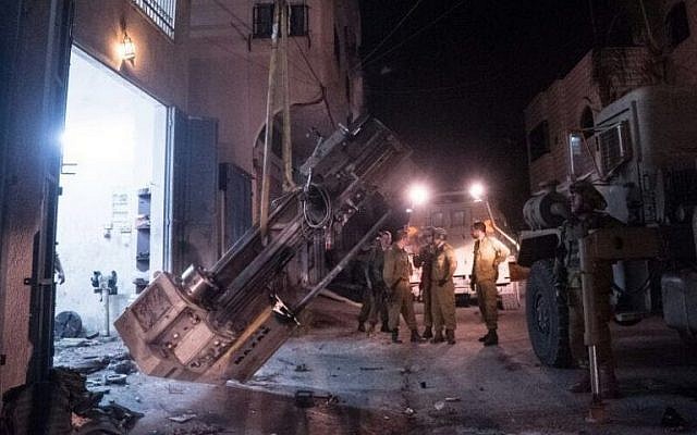 IDF troops remove weapon-making machinery from a workshop in the West Bank, in an image released August 1, 2016. (IDF Spokesperson)