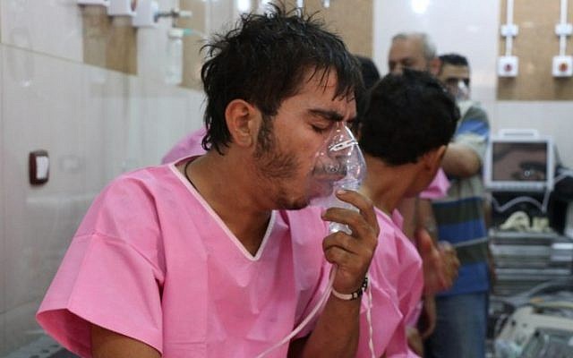 A Syrian man suffering from breathing difficulties is treated at a make-shift hospital in Aleppo on September 6, 2016. AFP/ THAER MOHAMMED)