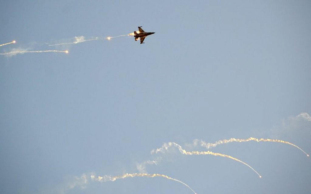 Illustrative: An Israel Air Force F-16 fighter jet fires off flares during a demonstration on December 31, 2015. (Hagar Amibar/Israel Air Force/Flickr)