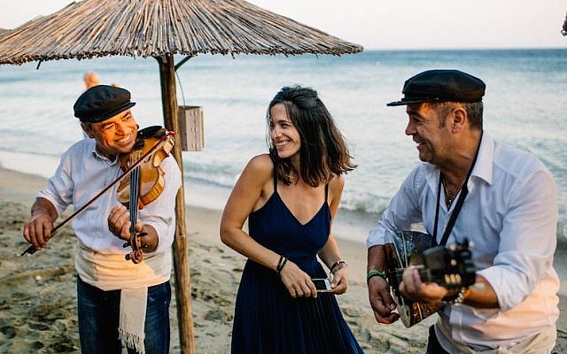 Wedaway founder and CEO Gal Zahavia sharing a moment with Greek musicians in Tinos, Greece, June 24, 2016. (We Are Red/JTA)