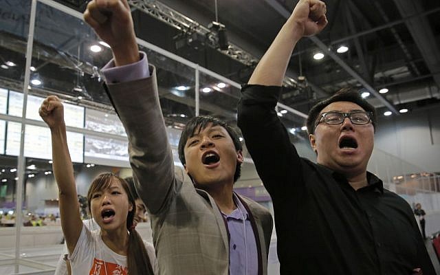Candidates from Youngspiration group celebrate after Yau Wai-Ching (left) won a seat in the legislative council election in Hong Kong, Monday, September 5, 2016. (AP Photo/Vincent Yu)