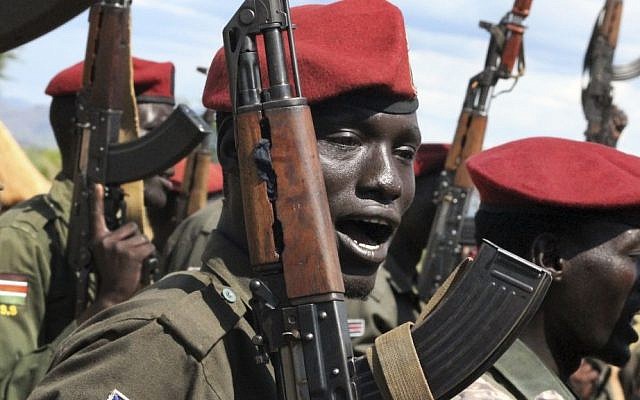 In this file photo taken April 14, 2016, government soldiers follow orders to raise their guns during a military parade in Juba, South Sudan. (AP Photo/Justin Lynch, File)