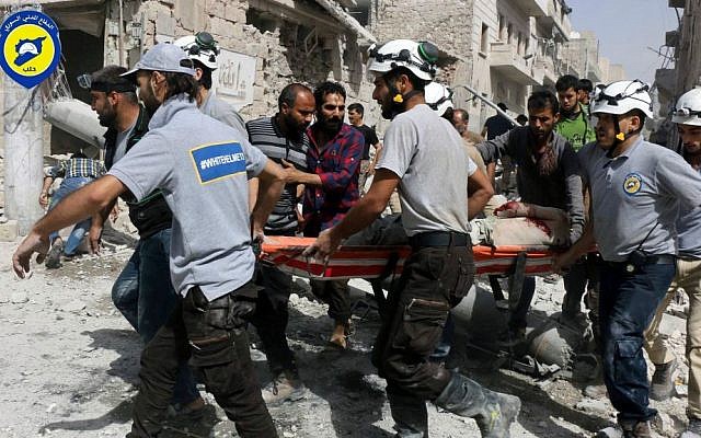 Rescue workers work at the site of airstrikes in the al-Sakhour neighborhood of the rebel-held part of eastern Aleppo, Syria, September 21, 2016. (Syrian Civil Defense White Helmets via AP)