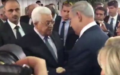 PA President Mahmoud Abbas and Prime Minister Benjamin Netanyahu shake hands before the funeral ceremony for Shimon Peres, Jerusalem, September 30, 2016 (YouTube screenshot)